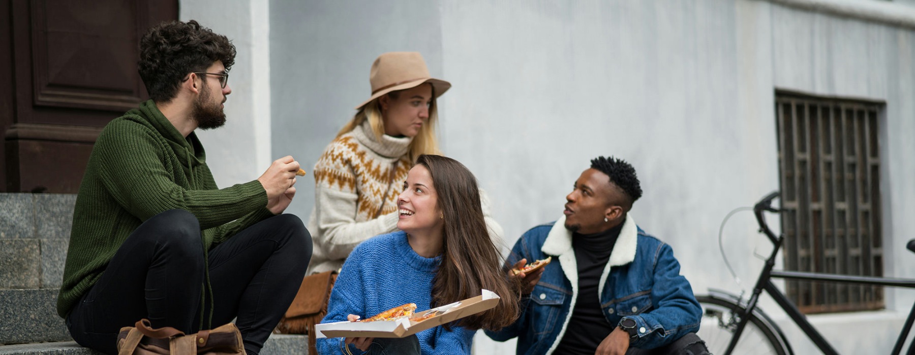 friends eating pizza outdoors