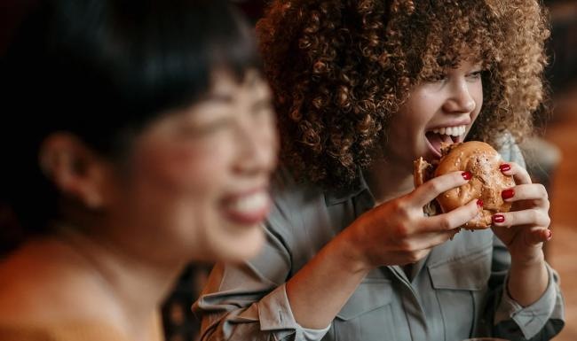 a man and a woman eating pizza